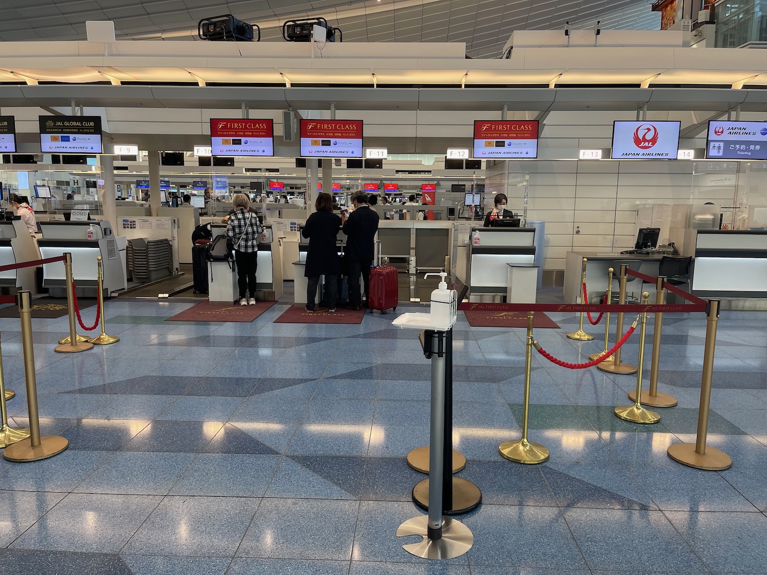 people standing in front of a check in counter