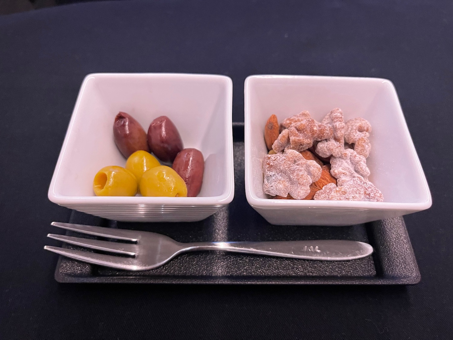 a couple of square white bowls with food in them