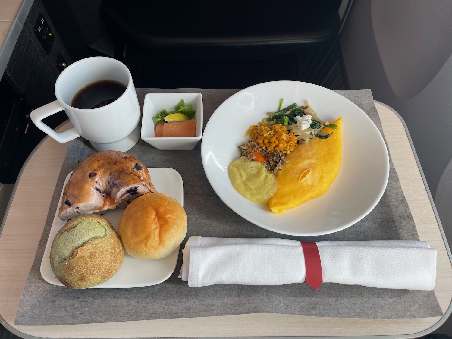 a plate of food and a cup of coffee on a table