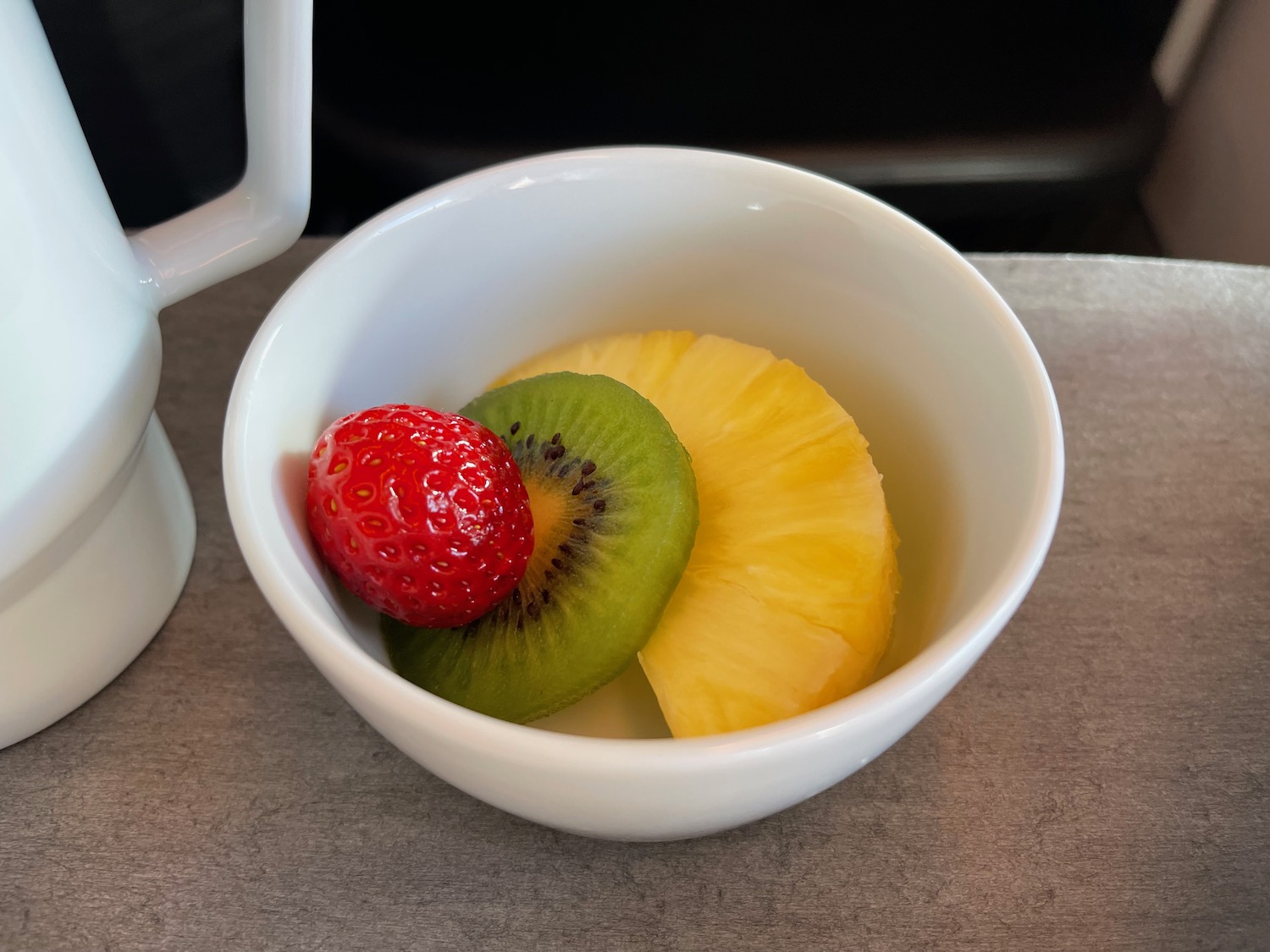 a bowl of fruit on a table