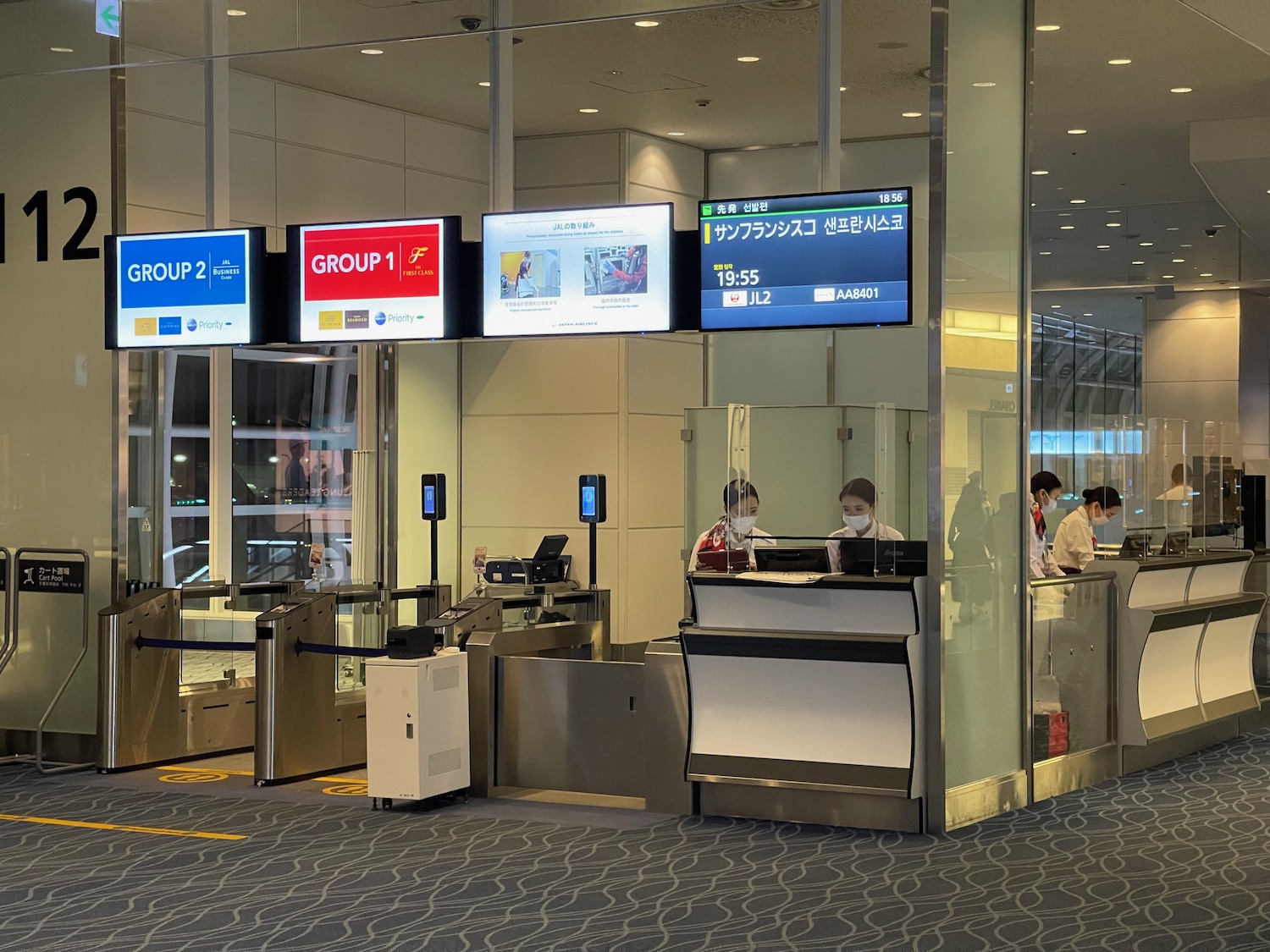 people at an airport check in counter