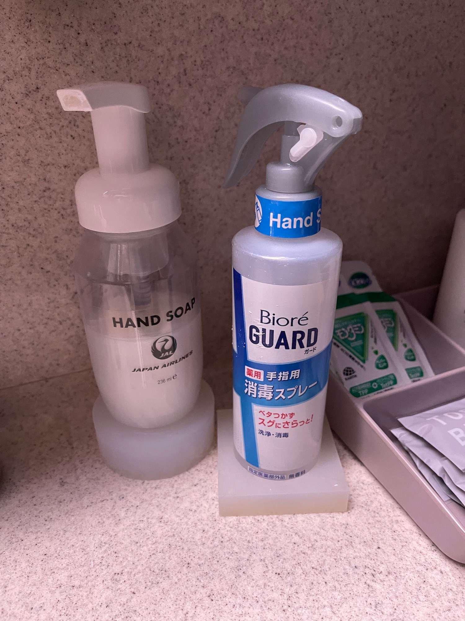 a bottle of hand soap and a hand soap container