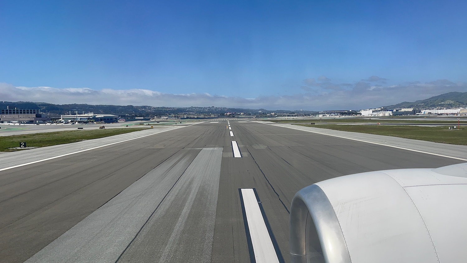 an airport runway with a plane on it