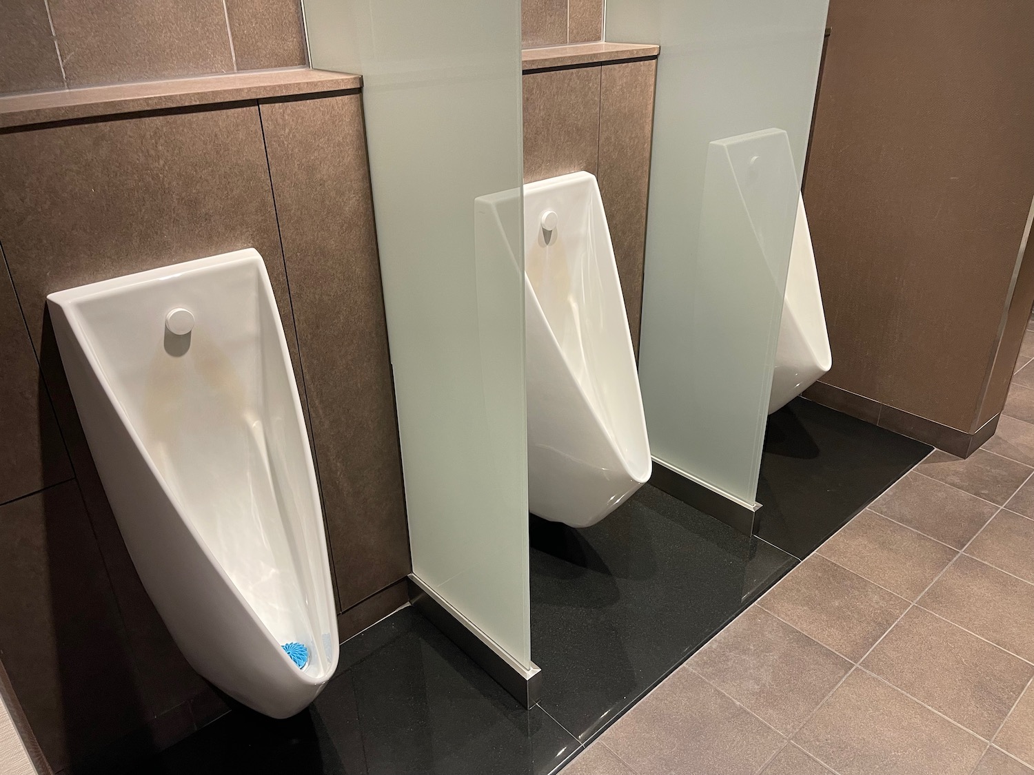 a row of urinals in a public bathroom