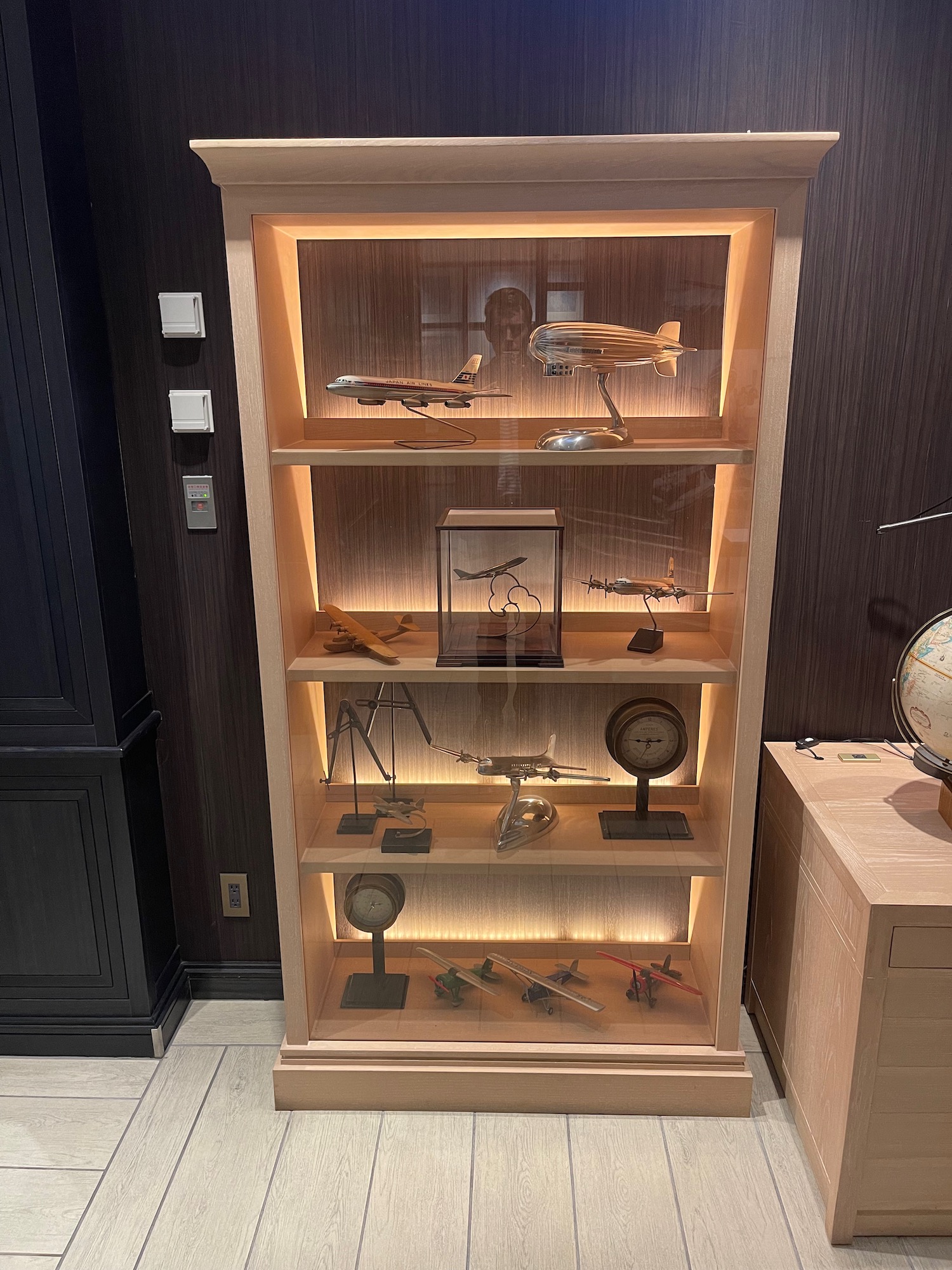 a display case with model airplanes and other objects