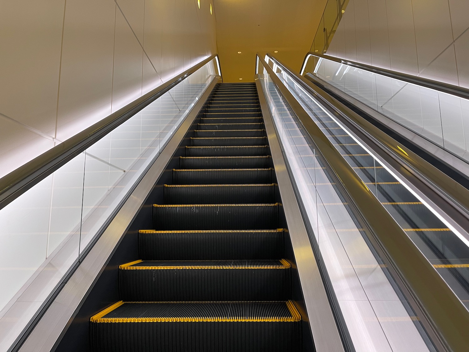 a escalator with yellow and black steps