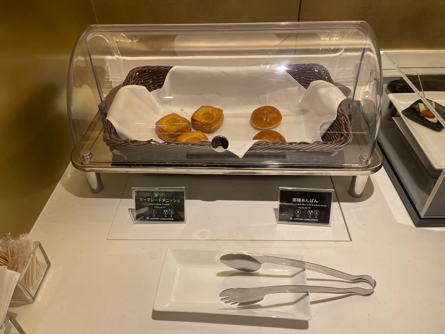 a tray of bread in a glass case