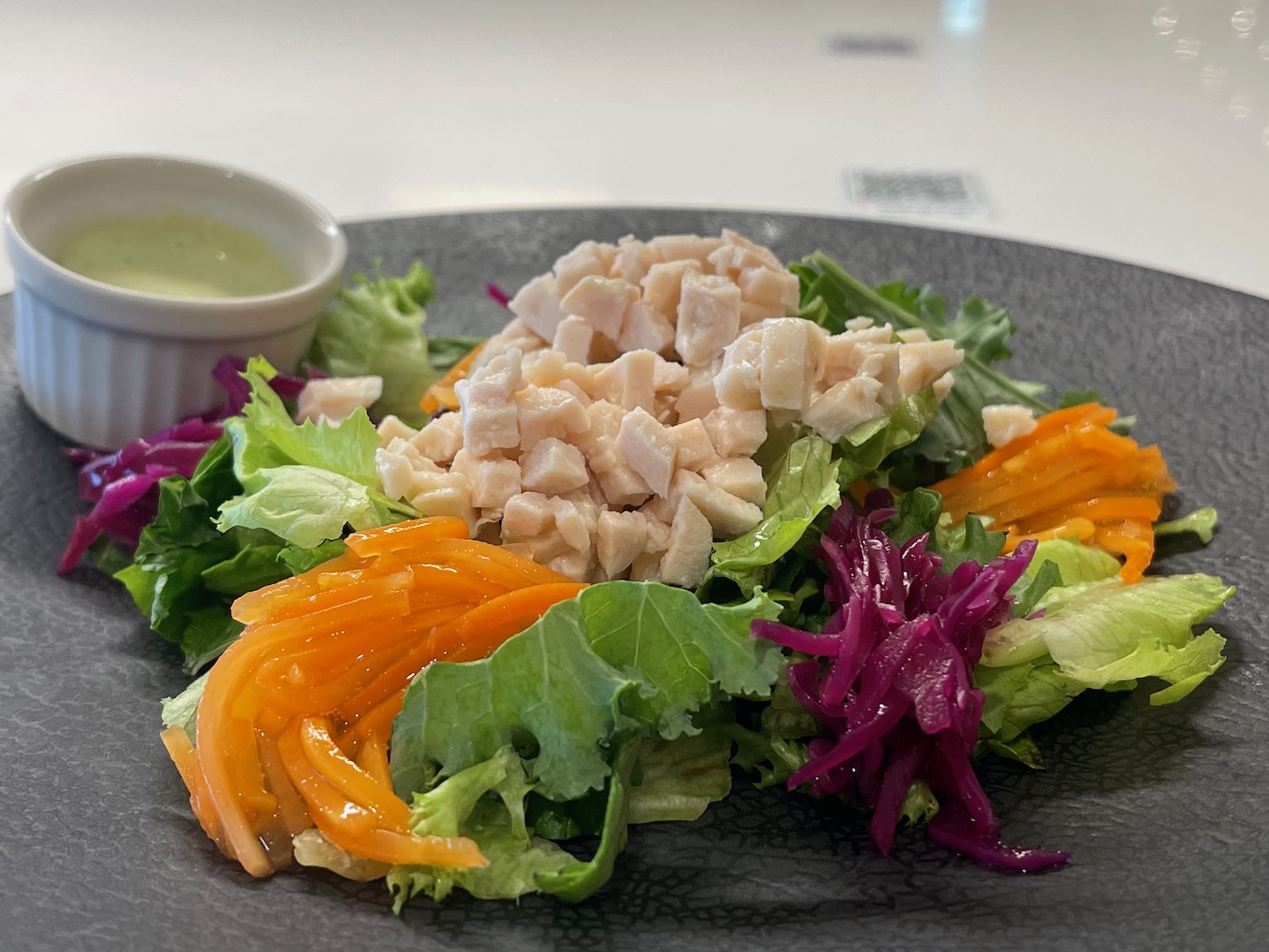 a plate of salad with a sauce