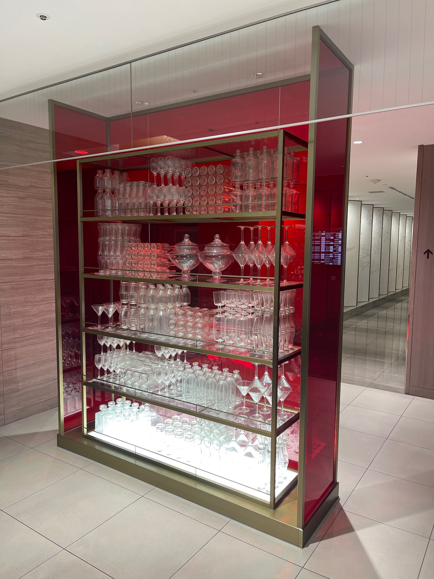 a glass shelves with wine glasses