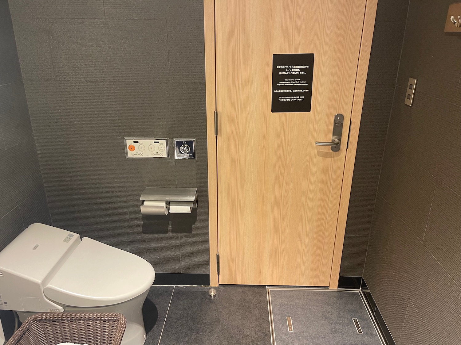 a bathroom with a door and a toilet