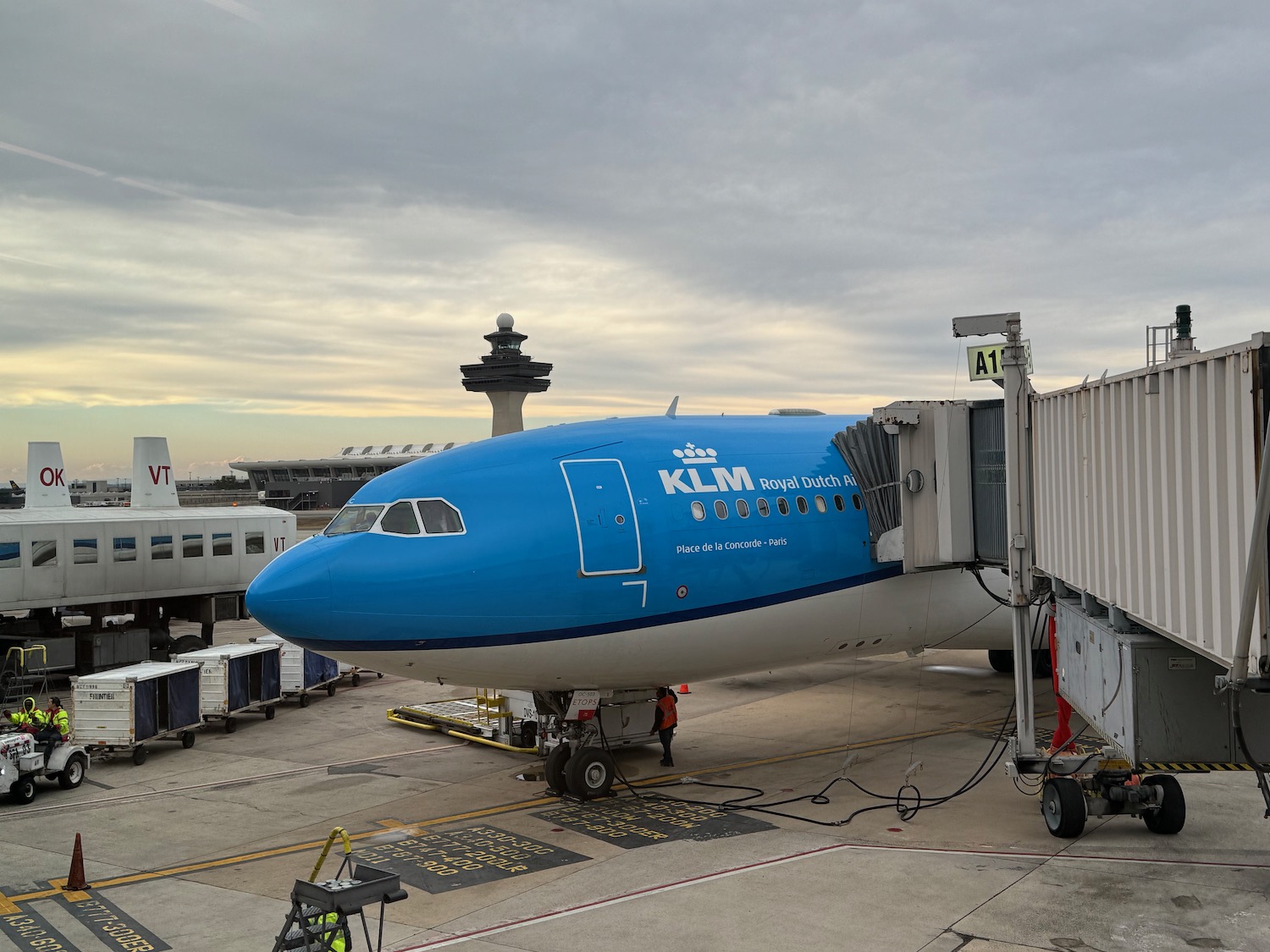 a blue and white airplane at an airport