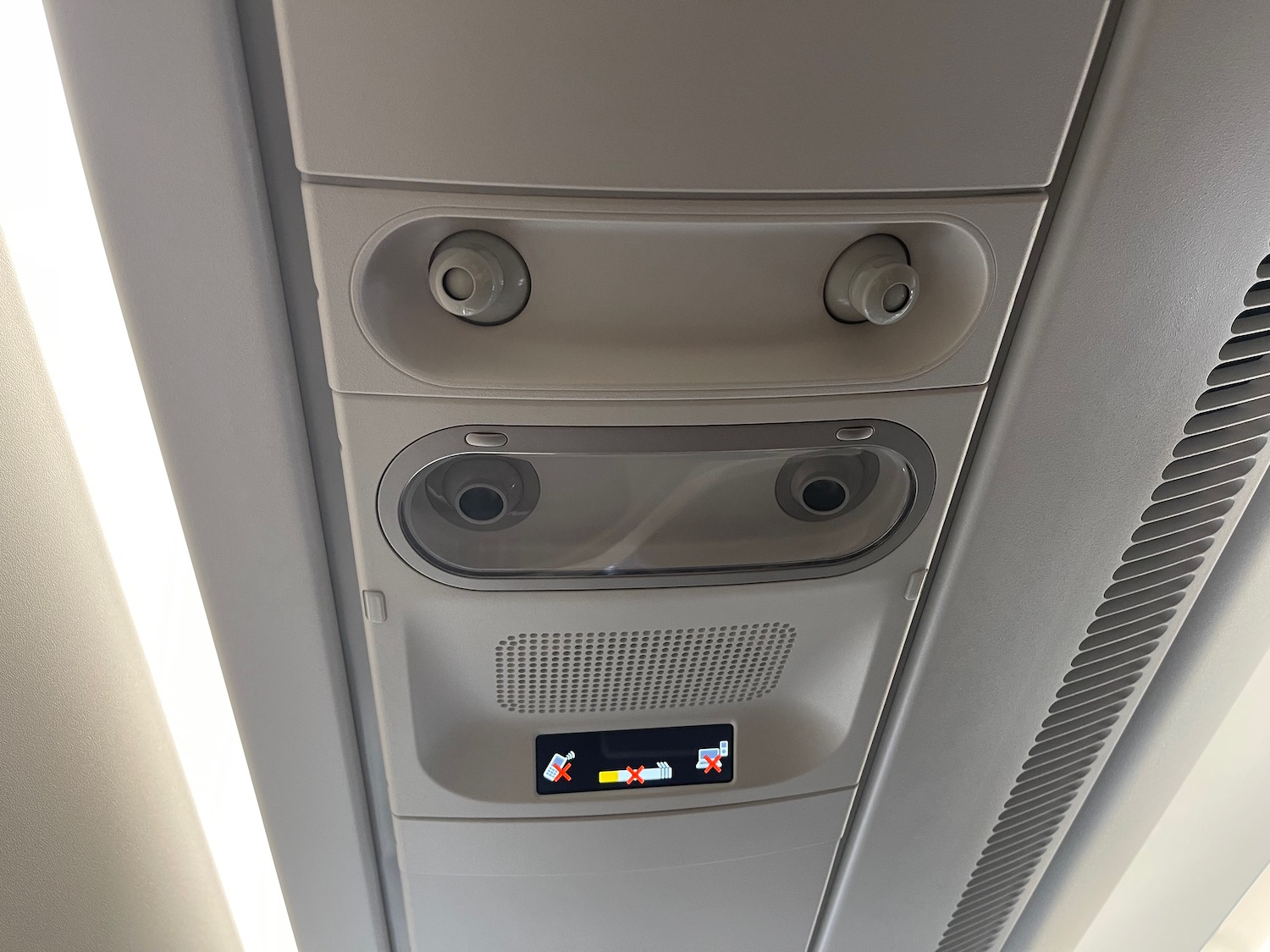 a overhead ceiling with a speaker and a sign