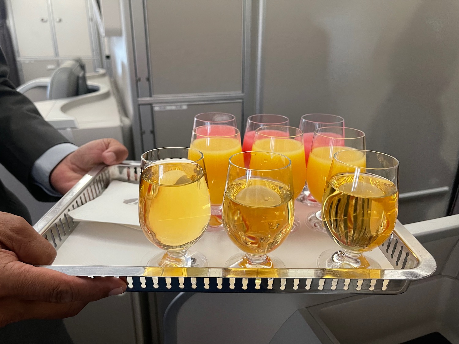 a tray of glasses filled with yellow liquid