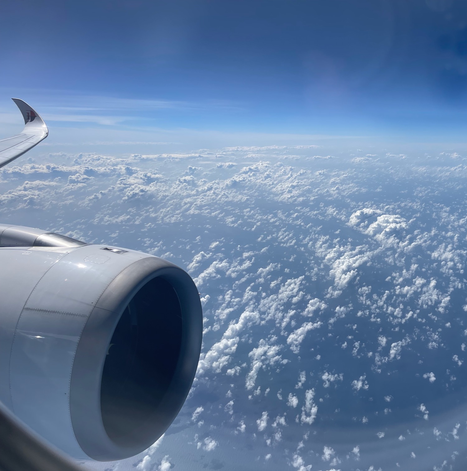 an airplane wing and clouds