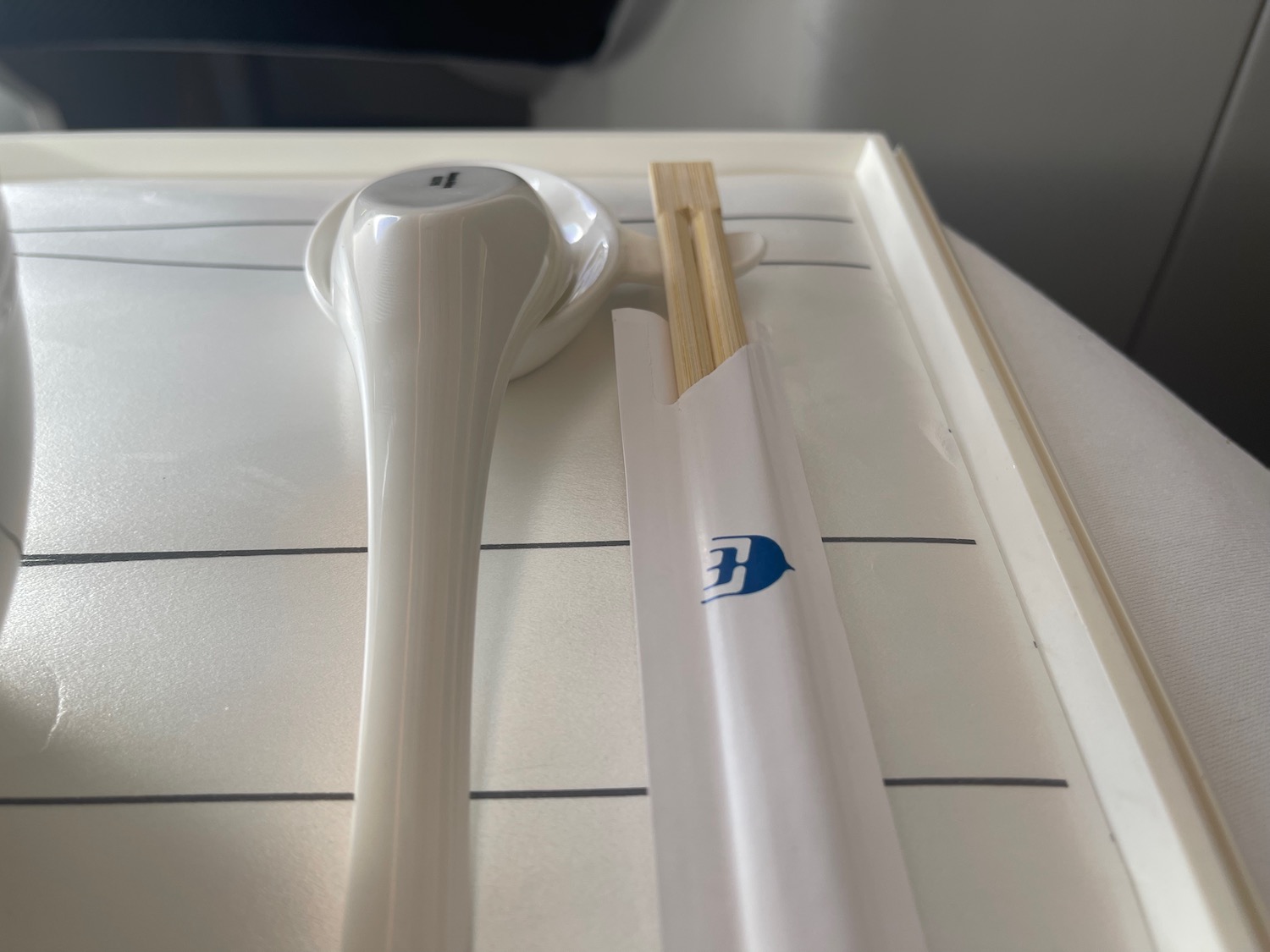 a spoon and chopsticks on a tray