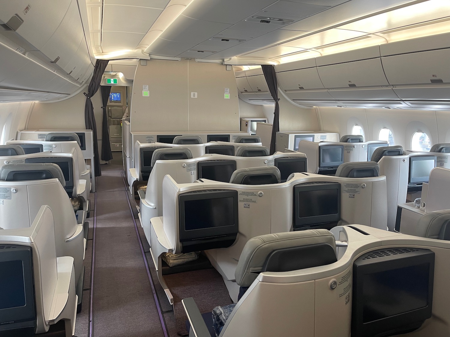 a plane with rows of seats and monitors