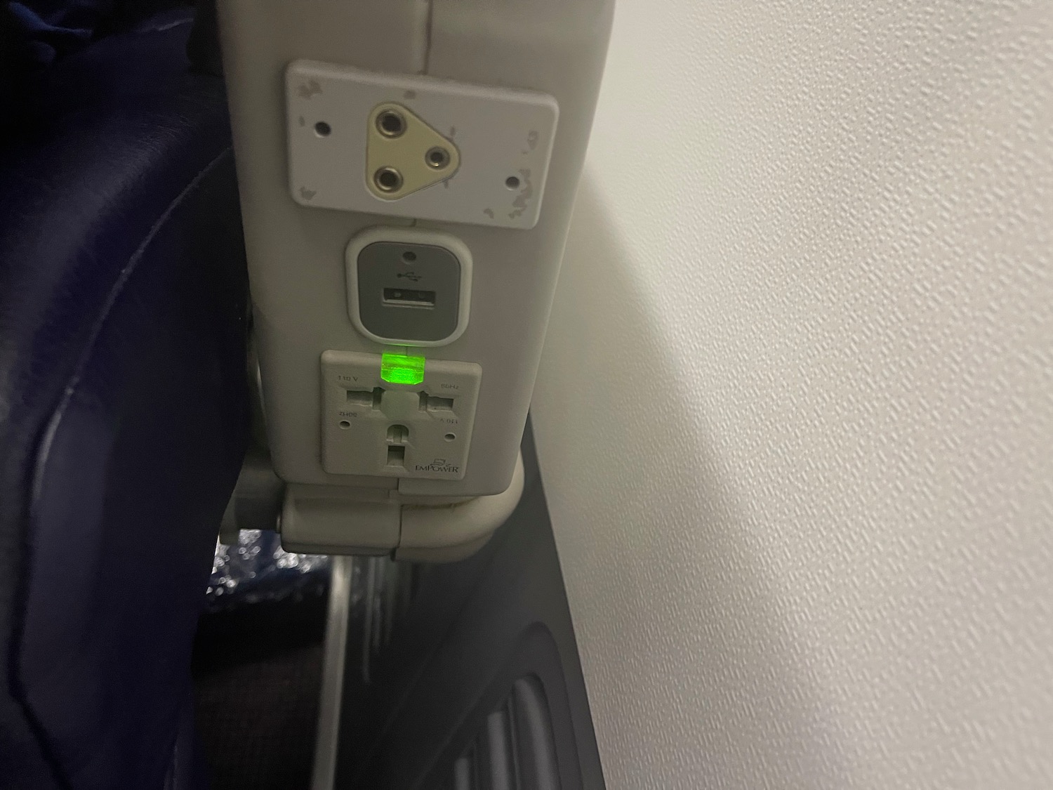 an electrical outlet with a green light
