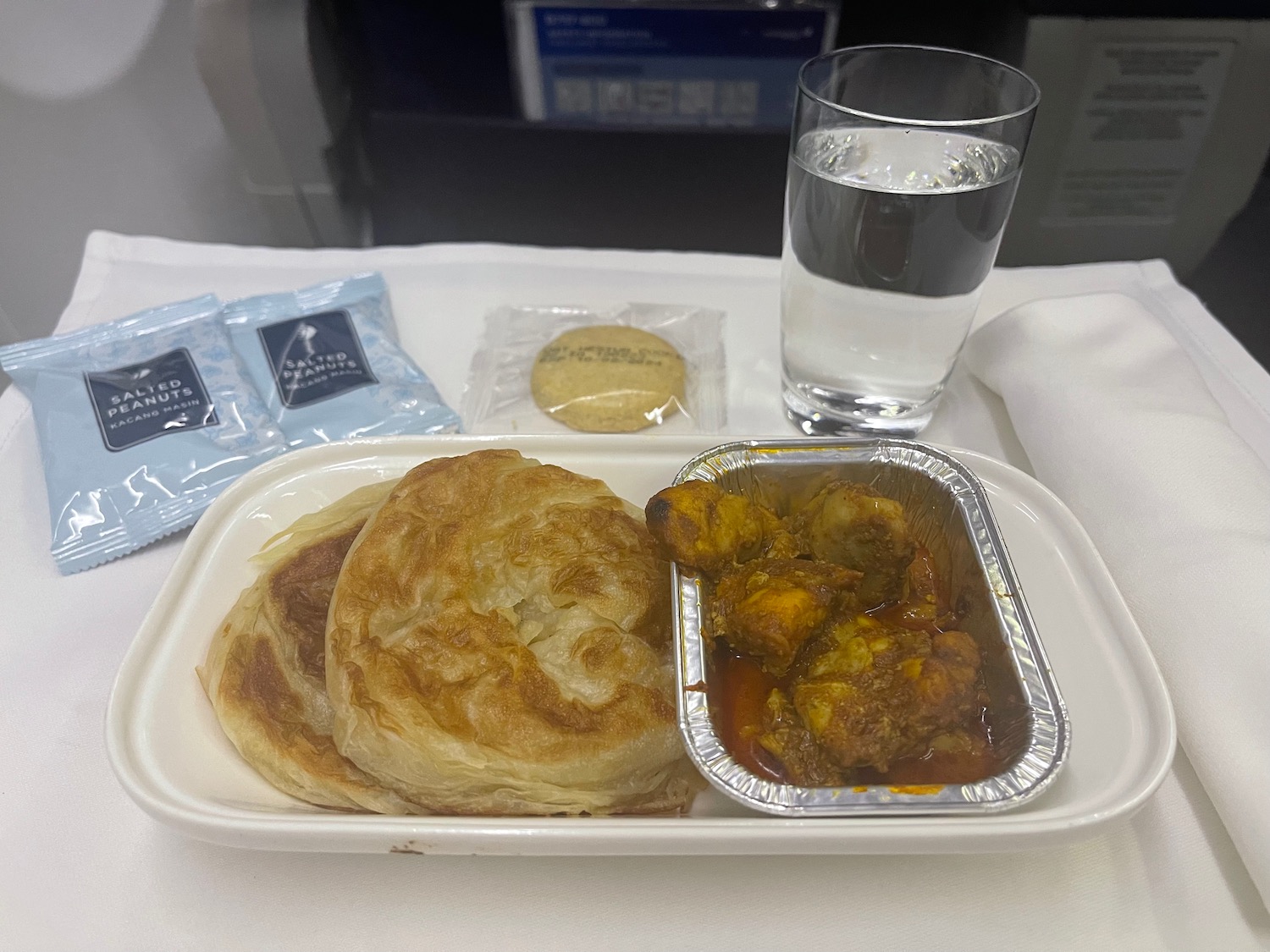 a tray of food and a glass of water