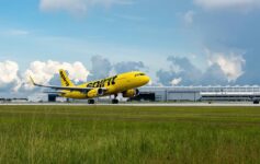 a yellow airplane on a runway