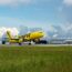 a yellow airplane on a runway