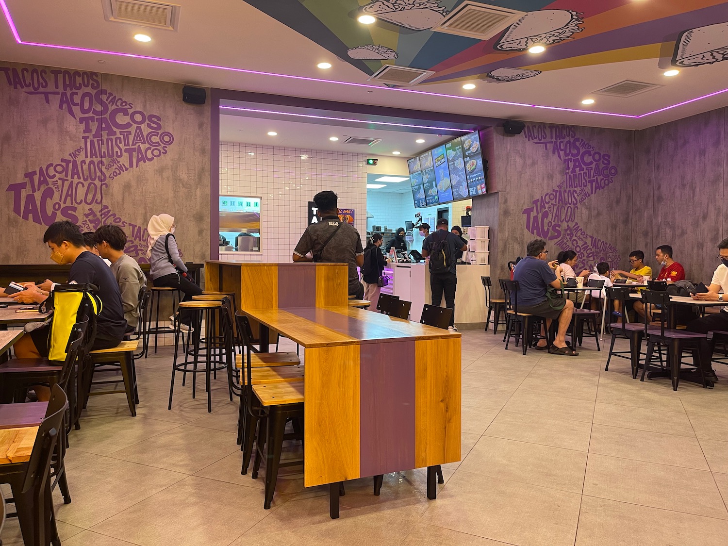 a group of people sitting at tables in a restaurant