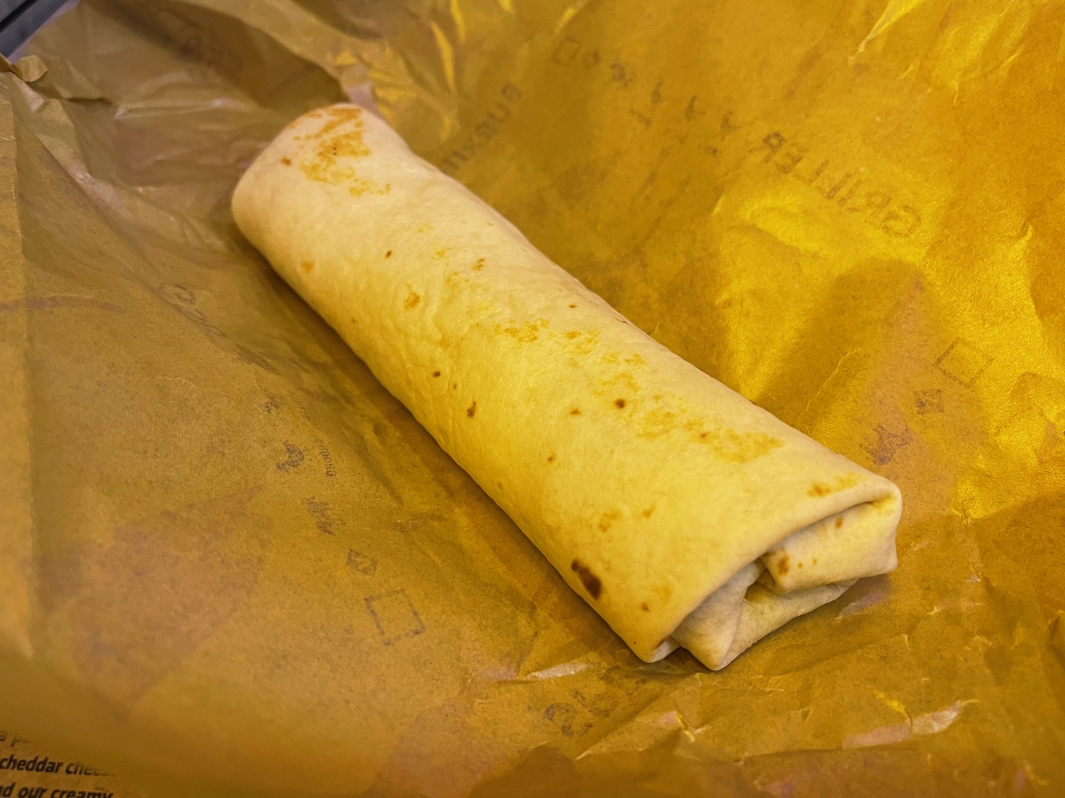 a burrito on a brown paper