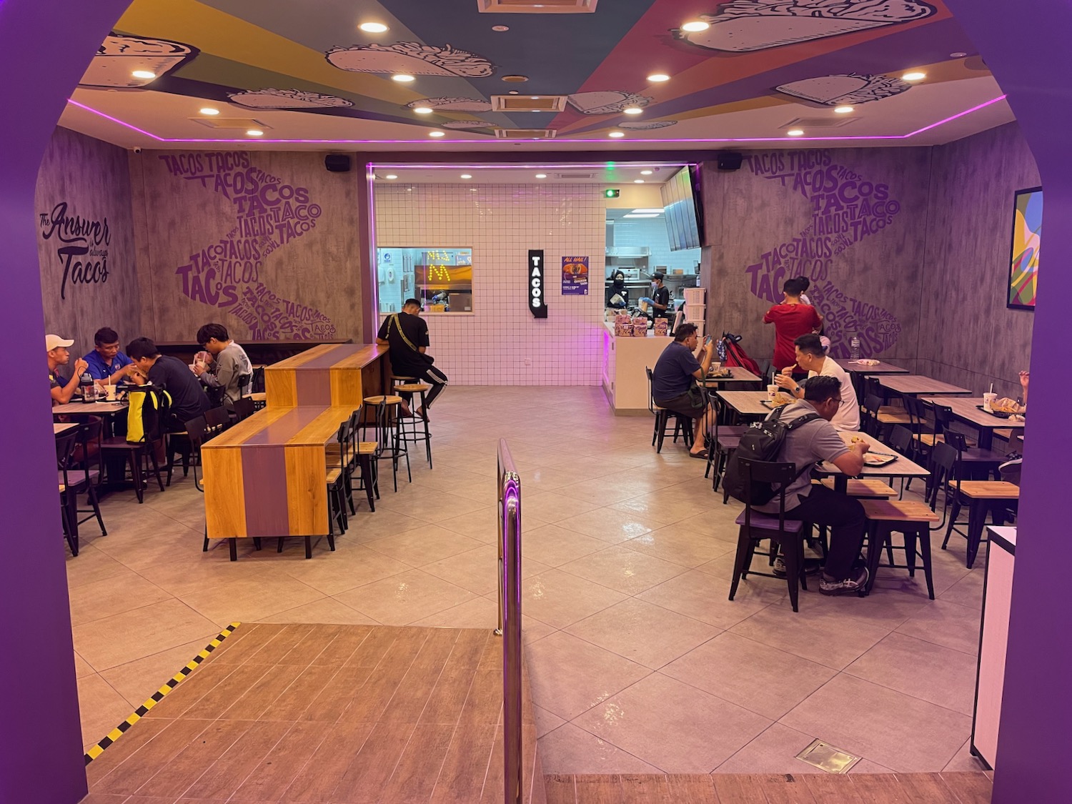 a group of people sitting at tables in a restaurant