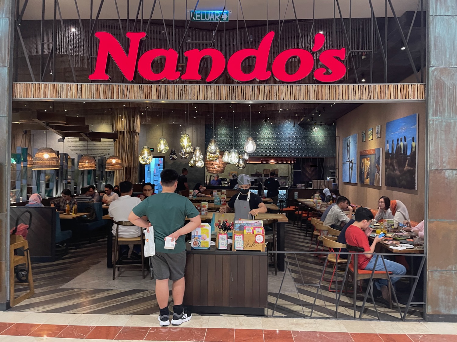 a group of people sitting at tables in a restaurant