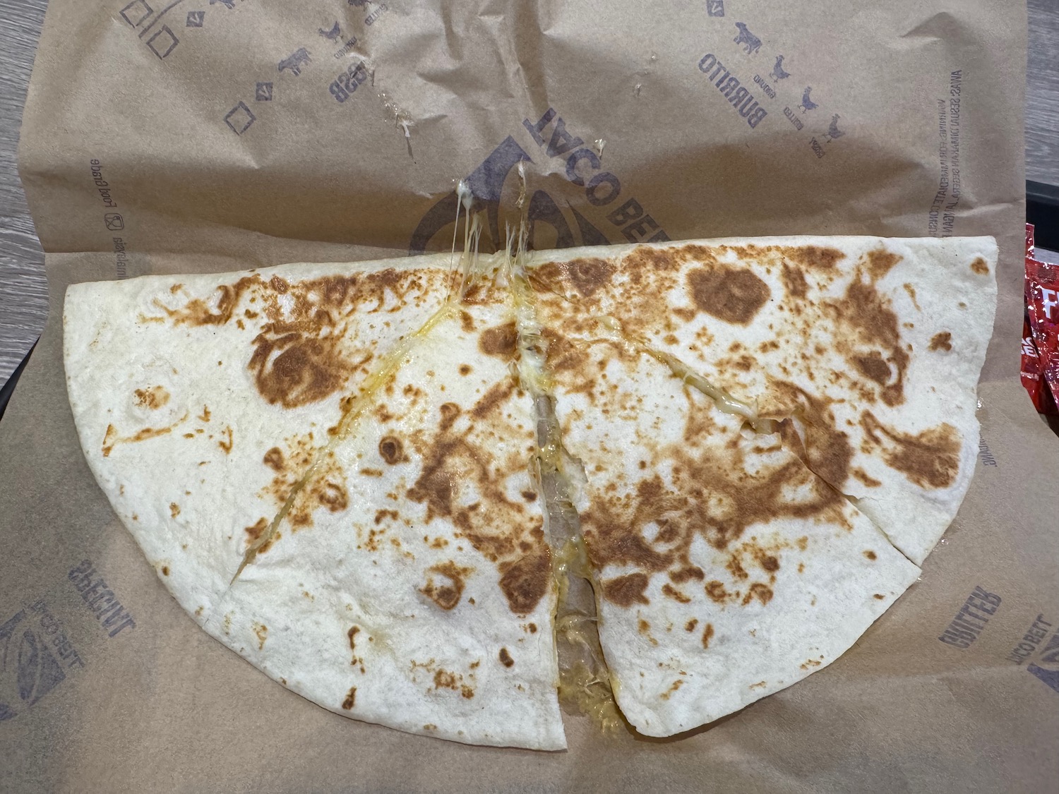 a quesadilla on a paper bag