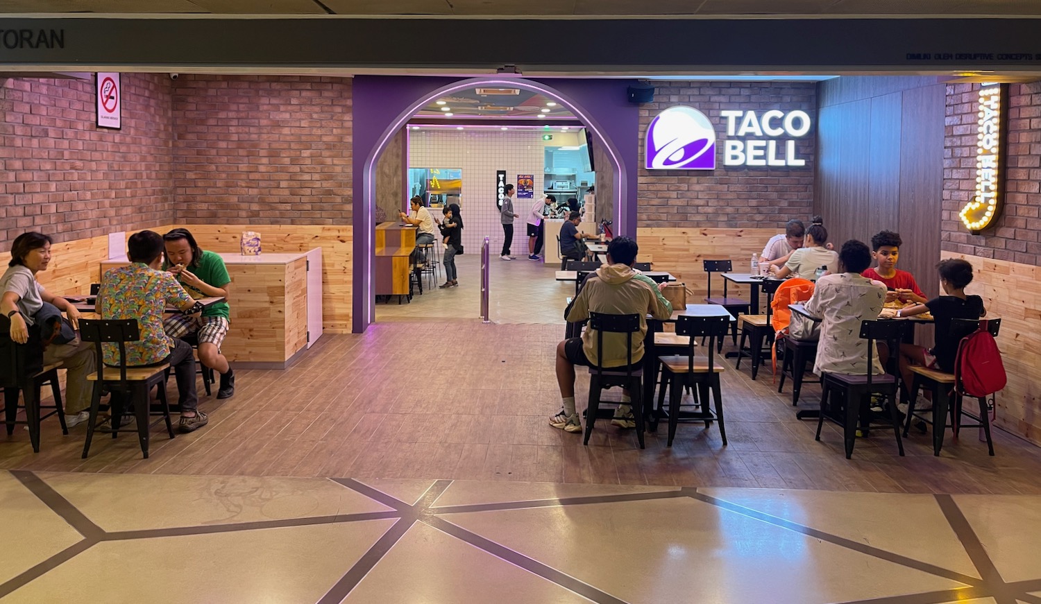 people sitting at tables in a restaurant