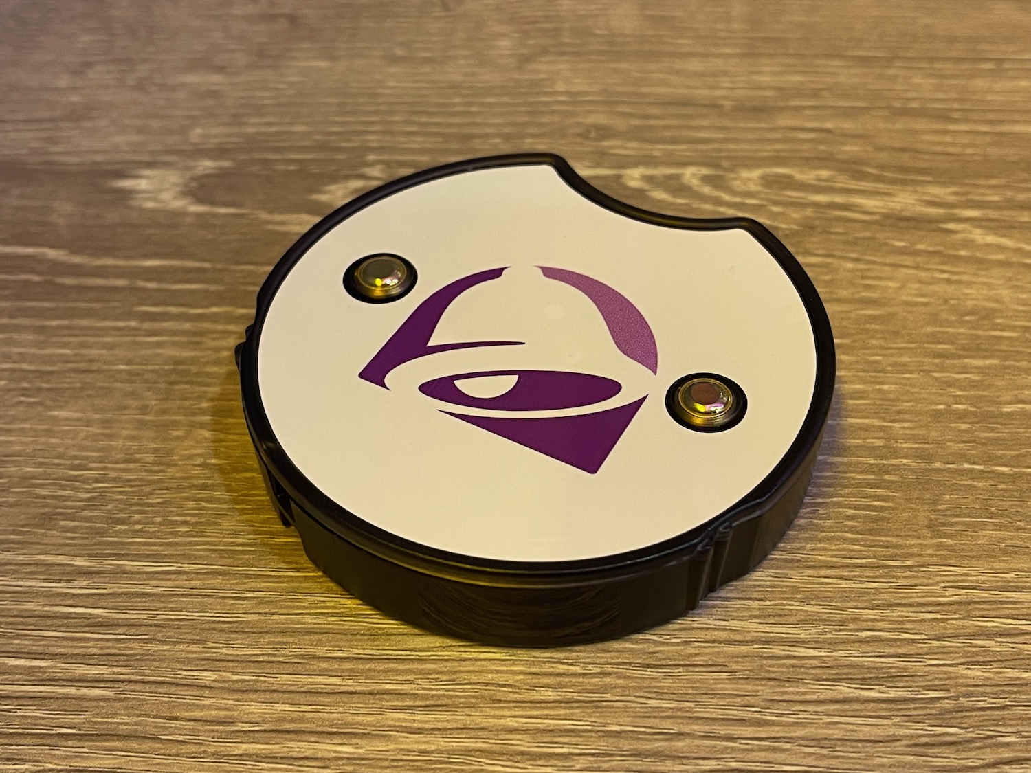 a round white and purple object with a logo on it