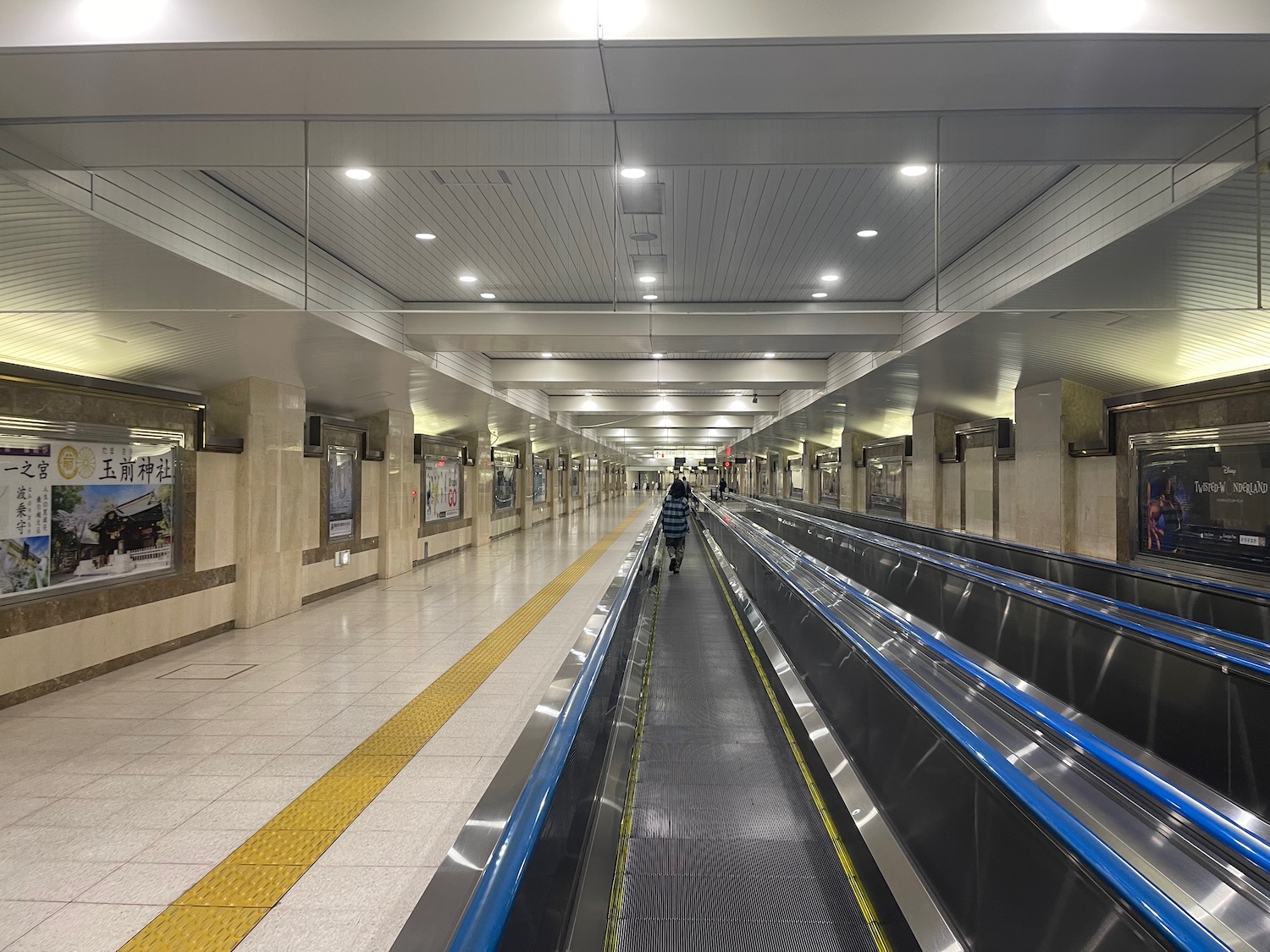 a person walking on a moving escalator