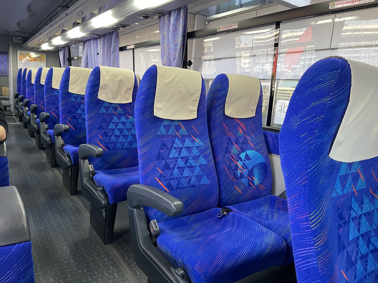 a row of blue seats on a train