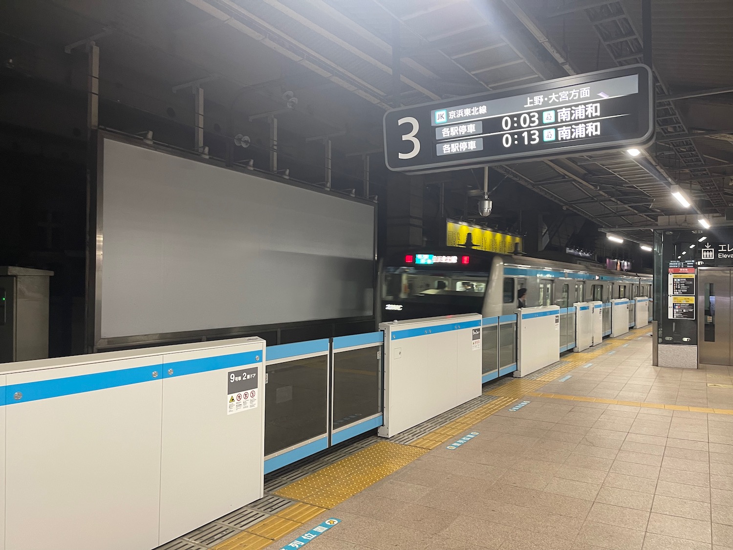 a train station with a row of white and blue objects