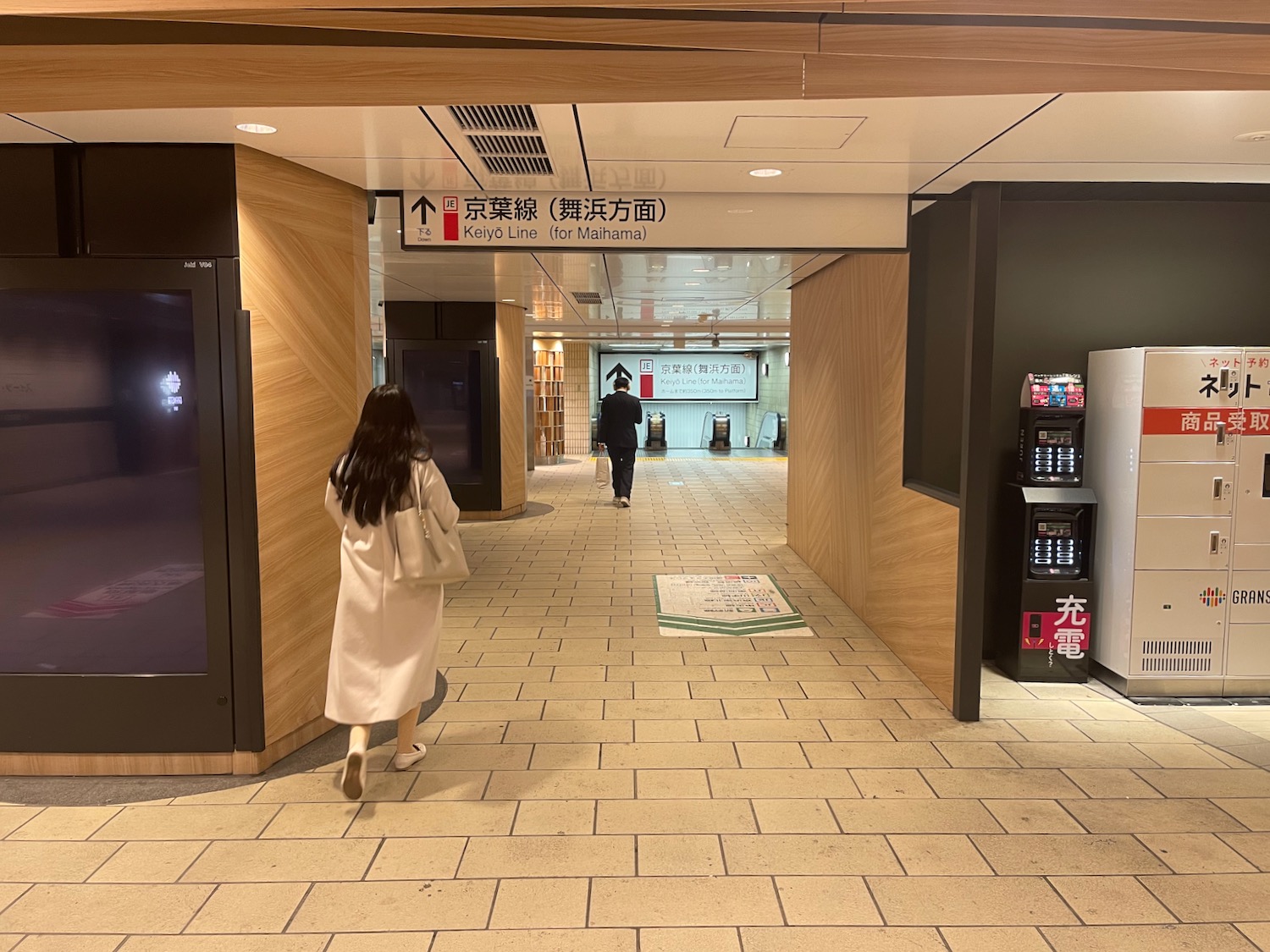 a woman walking in a hallway