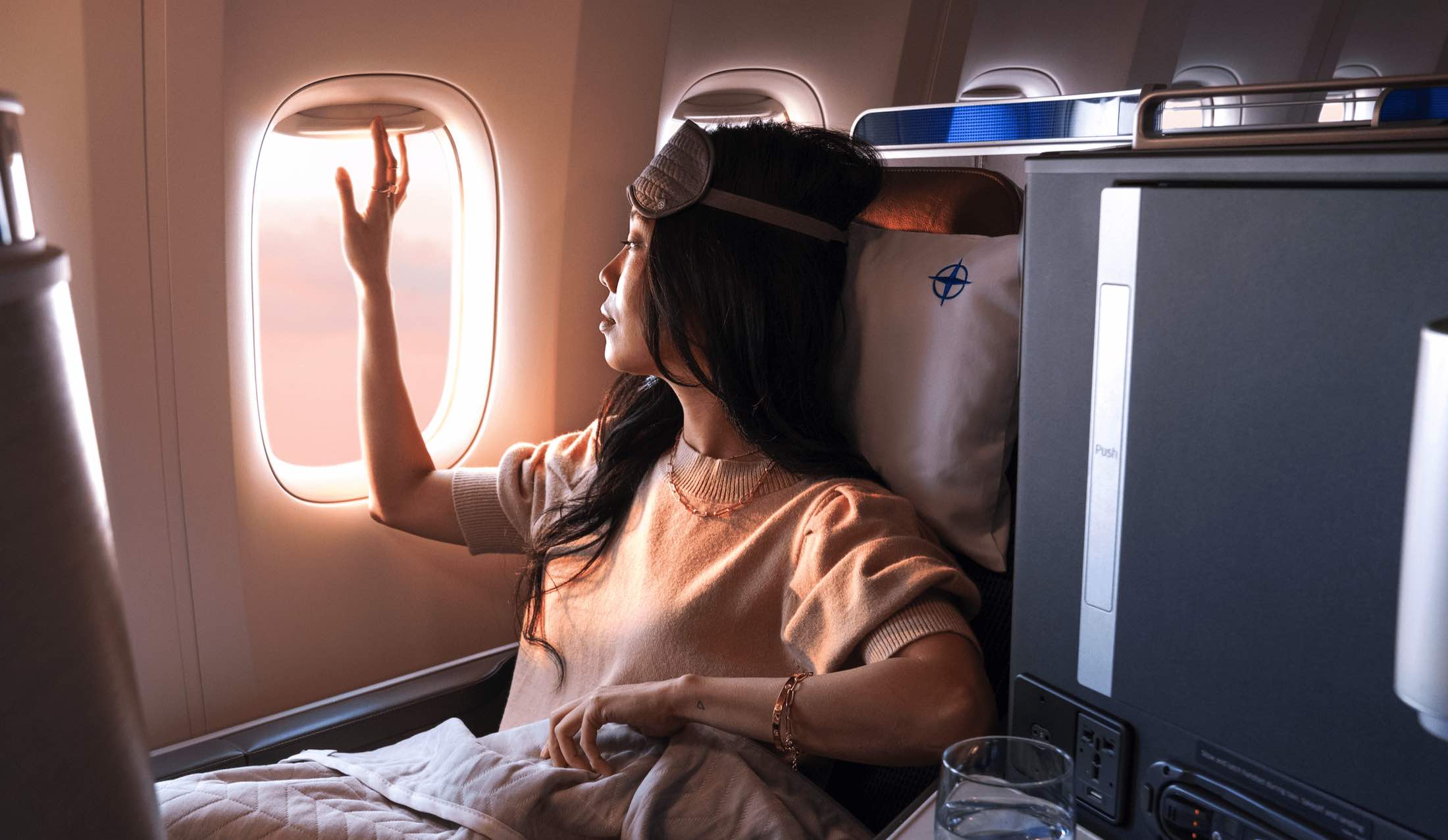 a woman in an airplane looking out the window