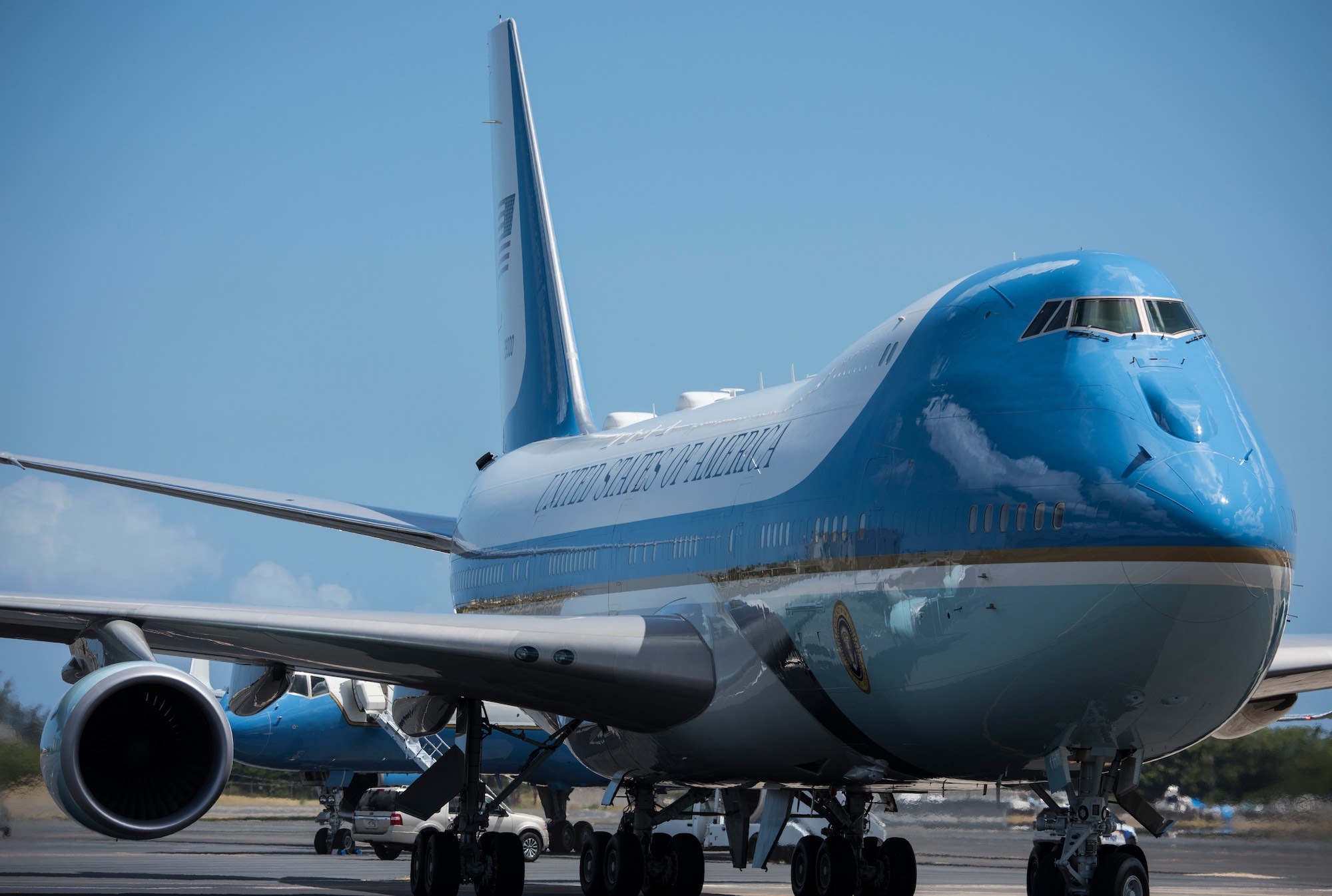 a blue and white airplane on a runway