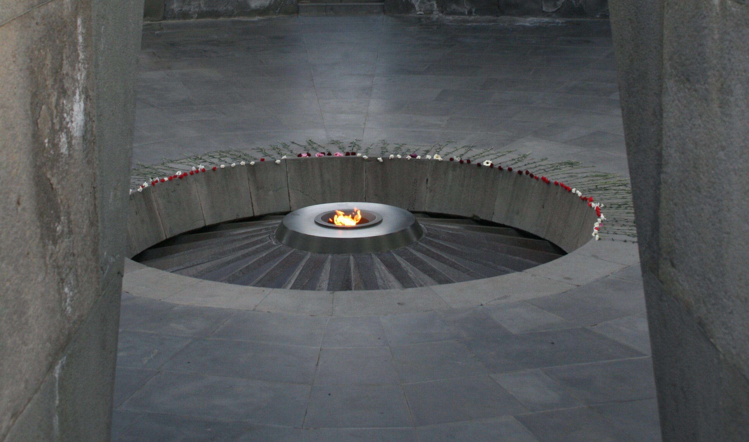 a circular fire pit with flowers around it