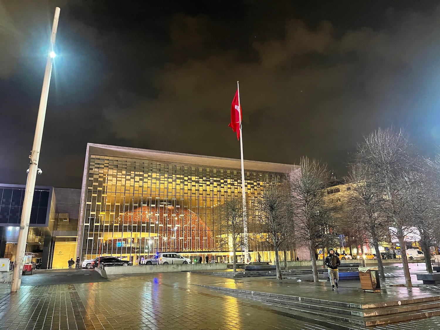 a building with a flag pole and trees