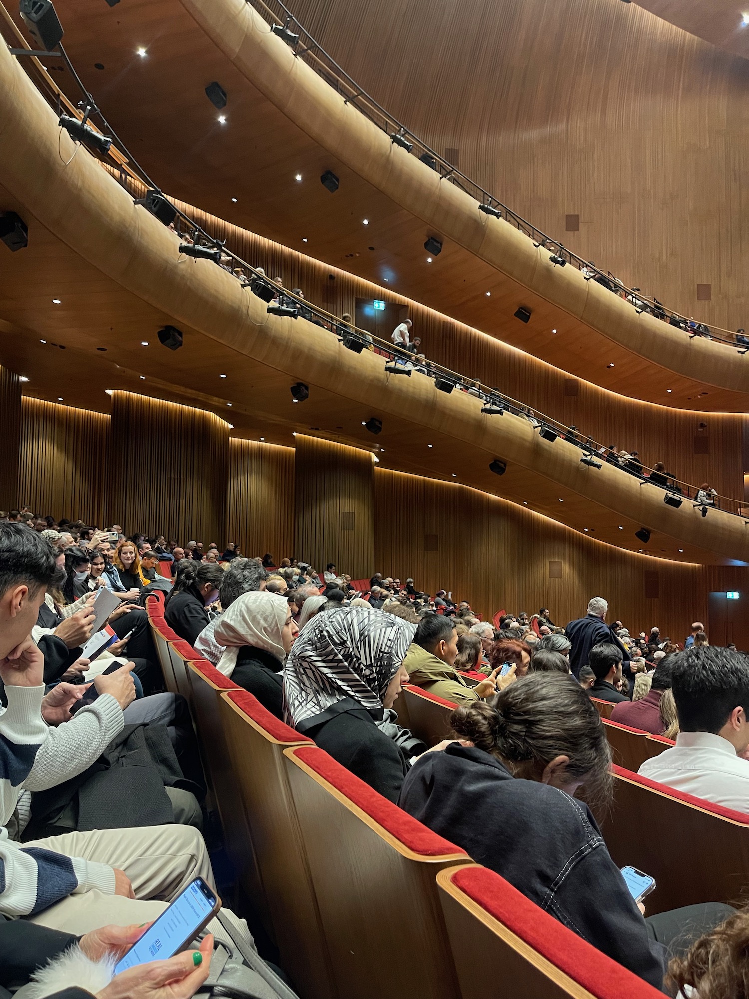 a group of people sitting in a auditorium