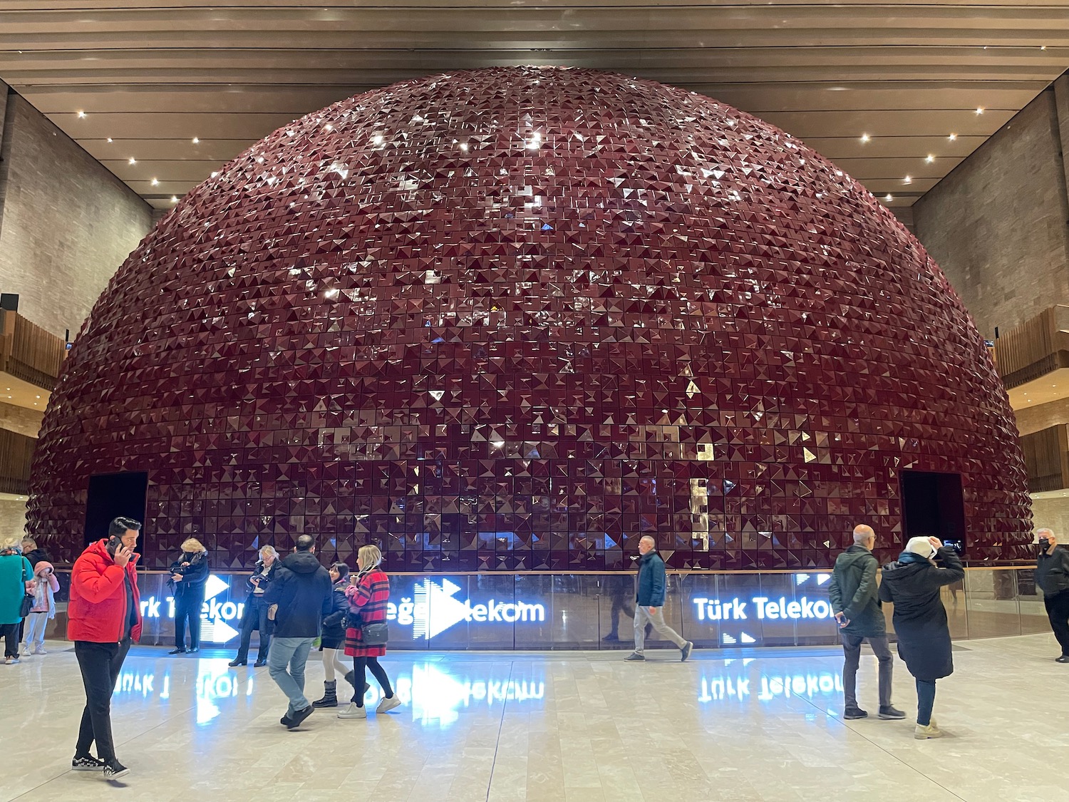 a large red sphere in a building