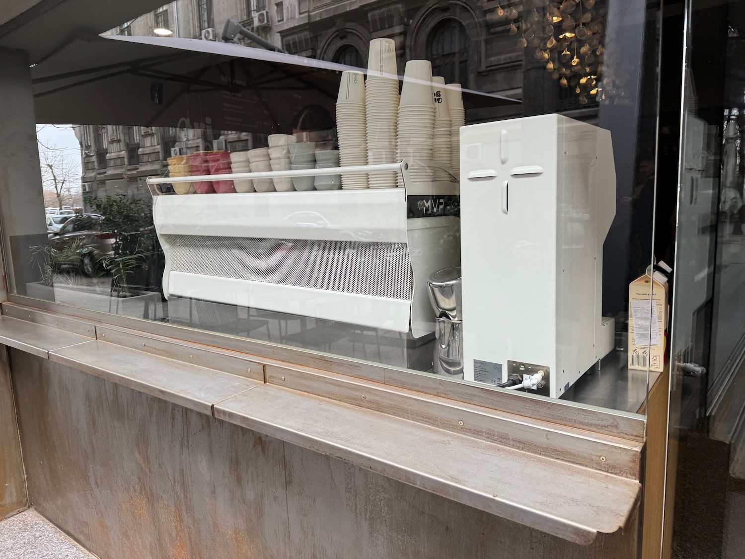 a coffee machine and cups in a store window