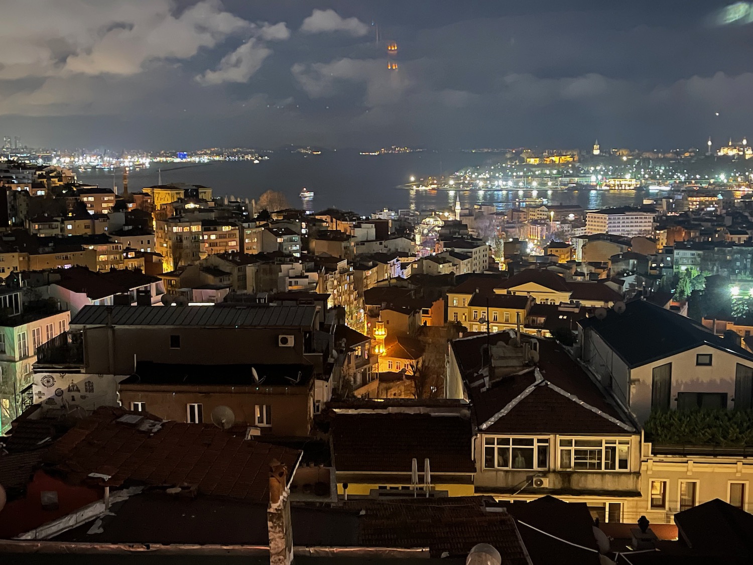 a city with lights and water in the background