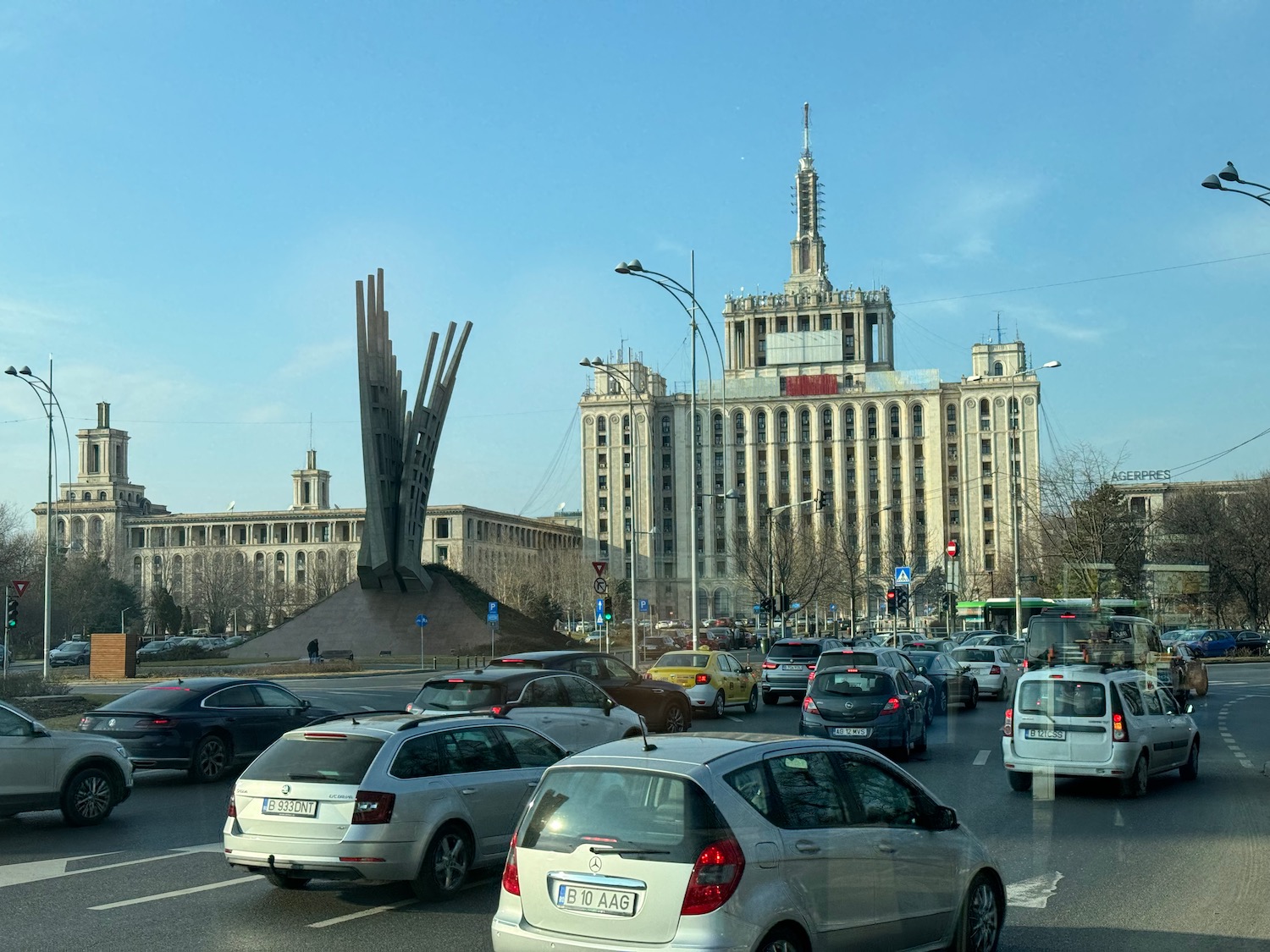 a traffic on a road with a large building in the background