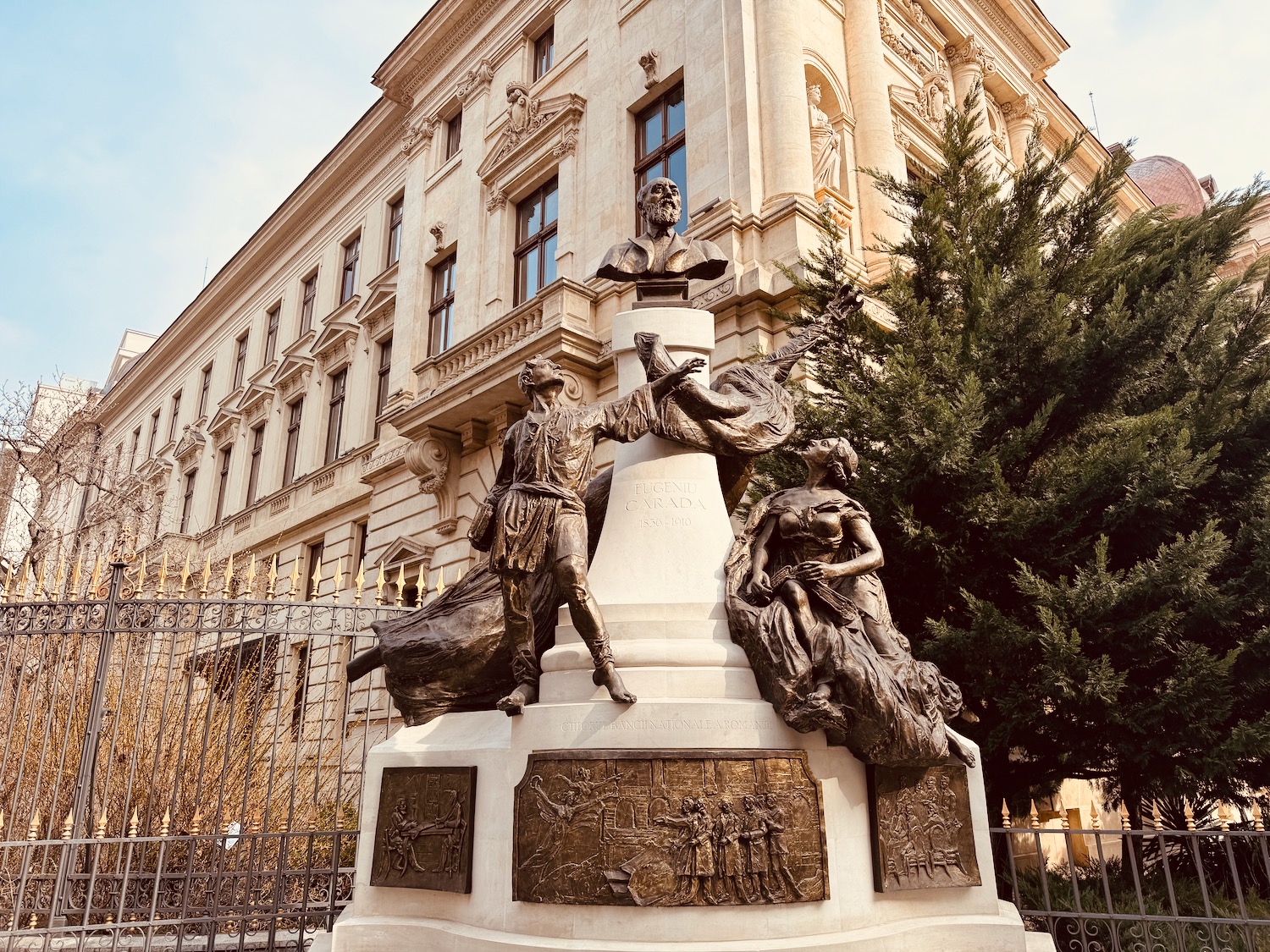 a statue of a man and woman in front of a building