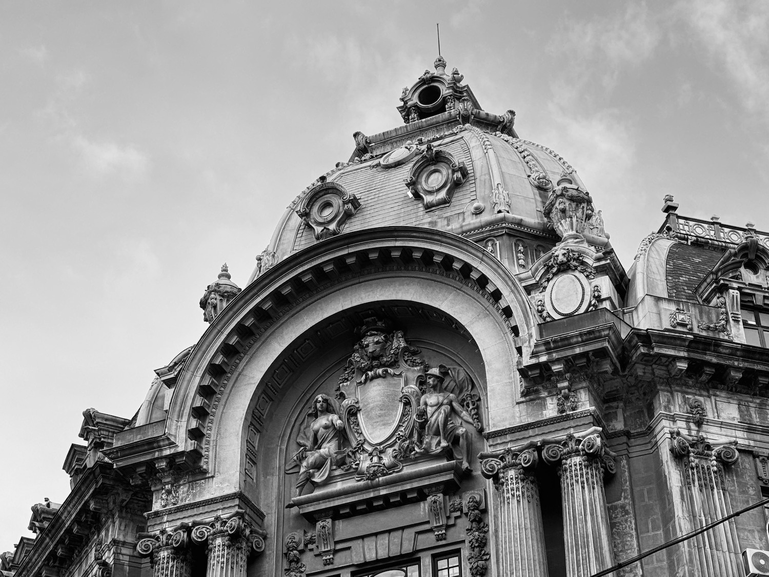 a building with a dome and a statue on top