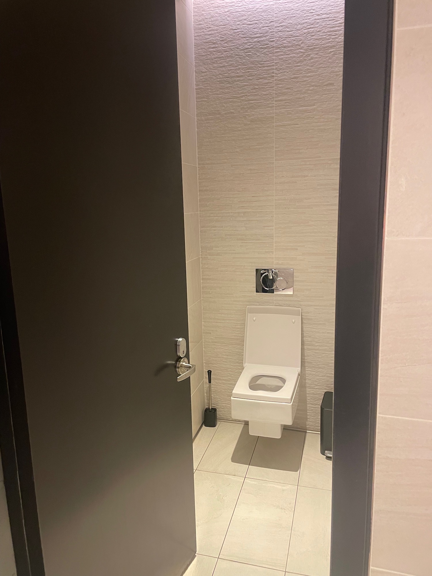 a bathroom with a toilet and a door
