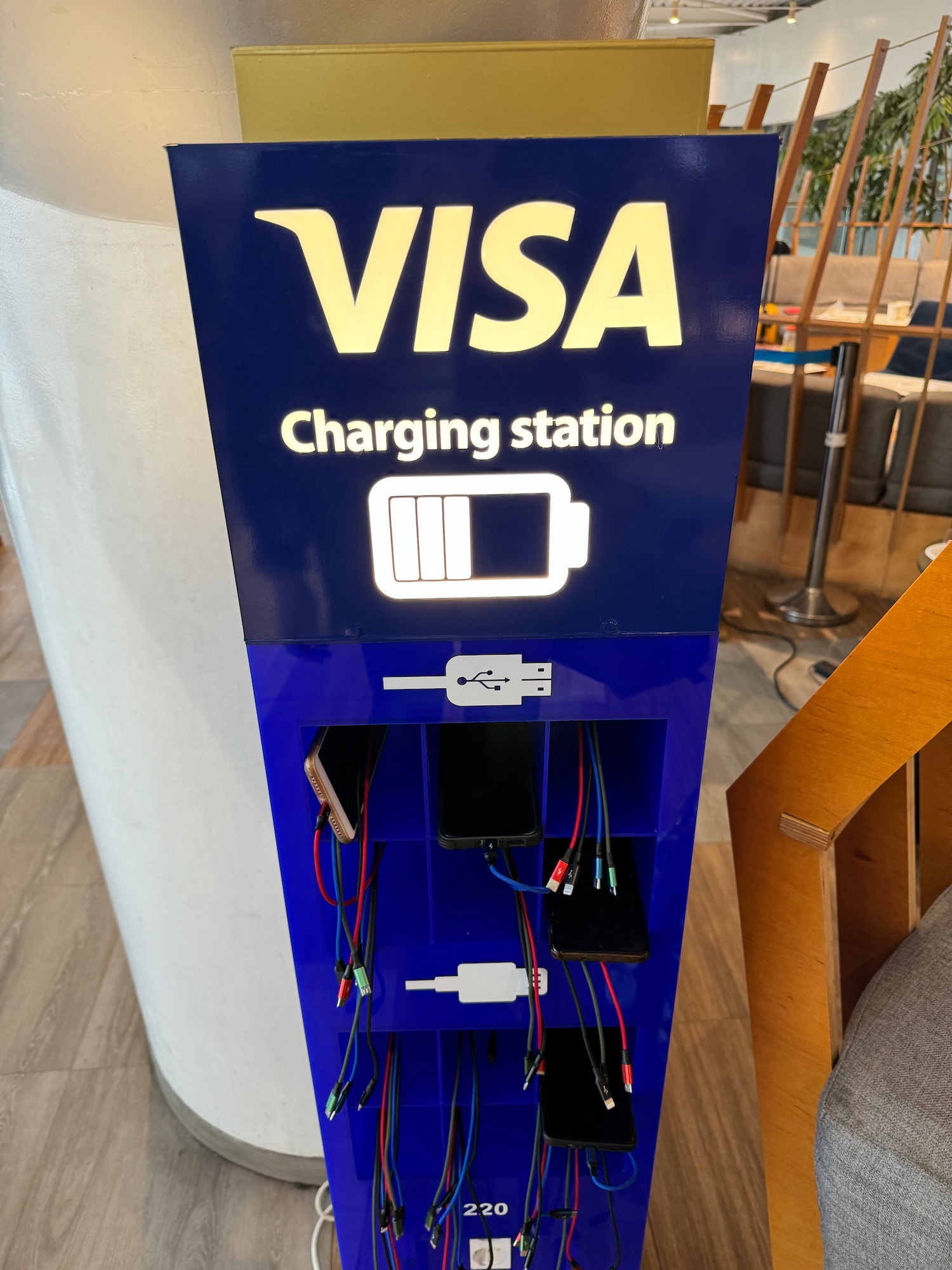 a charging station with wires and a sign