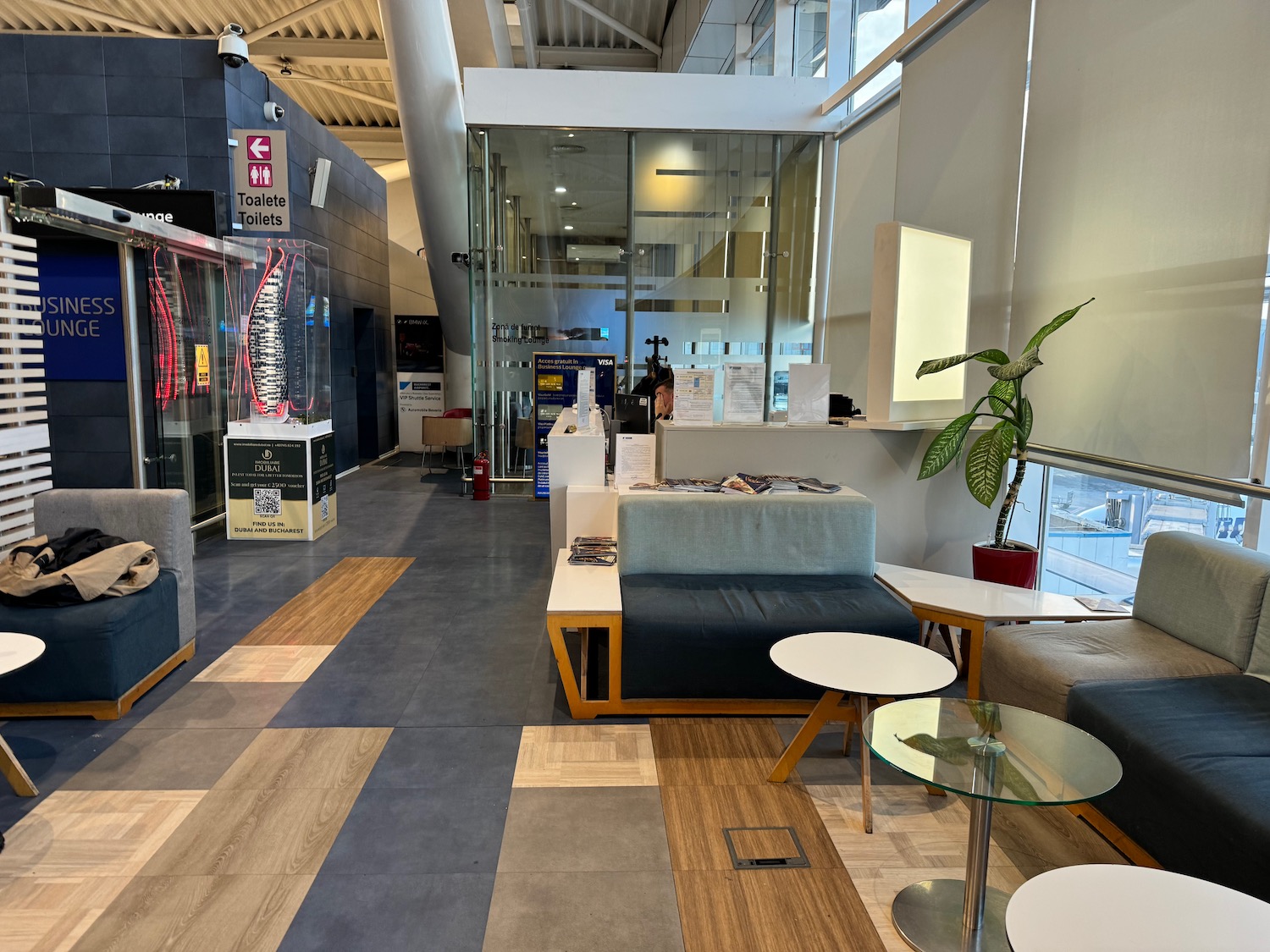 a lobby with a glass wall and a couch