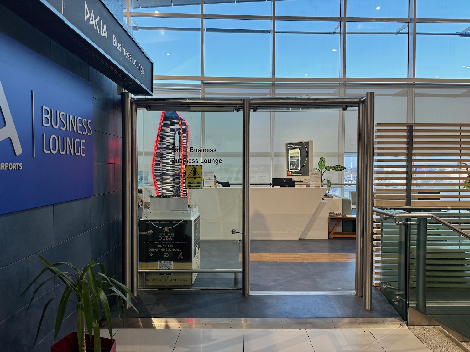 a glass door with a sign and a desk